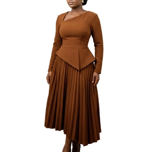 Detail of brown pleated dress showing the irregular neckline and textured fabric waist