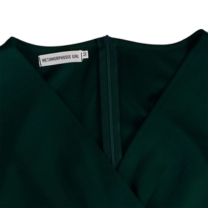 Detailed macro view of dark green dress with a deep V-neck and invisible back zipper