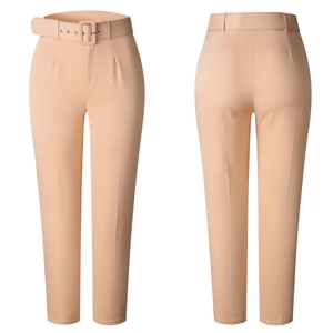 Detail view of high-waisted apricot straight-leg trousers with matching belt and pleats