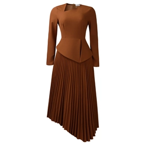 Detail showing the brown pleated midi dress with asymmetrical hem and diagonal neckline