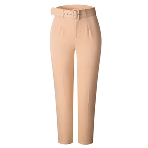 Detail of high-waisted apricot trousers with matching wide belt and sharp front pleats