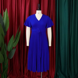 Close-up of royal blue V-neck dress with ruffle sleeves and pleated accordion skirt