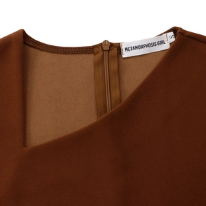 Detail view of the brown asymmetric collar with hidden zipper and woven brand tag