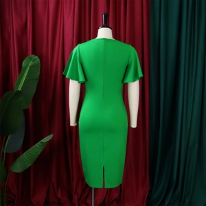 Detail of the back zipper and slit on a slim-fit green pencil dress with ruffle sleeves