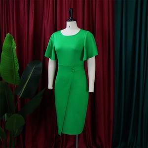Detail of green ruffle sleeve dress featuring waist buttons and a stylish front split hem