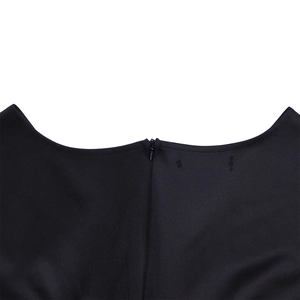 Detail shot of black dress showing deep V-neckline and smooth invisible zipper closure