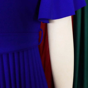 Close-up of pleated skirt texture and tiered ruffle sleeves on royal blue dress
