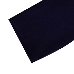 Detailed close-up of high-quality double-needle stitching on navy knit dress hemline