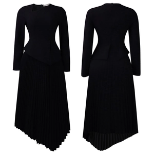 Detail of elegant black long sleeve dress with layered waist and asymmetrical pleated hem