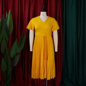 Detail of yellow V-neck pleated dress with ruffle sleeves and a matching square buckle belt