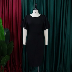 Detail view of black crew neck dress featuring elegant ruffle sleeves and slim fit cut