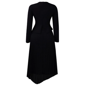 Detailed back view of a black high-waisted dress with asymmetric pleated skirt and peplum