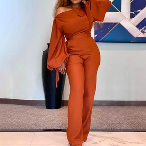 Detailed view of caramel off-shoulder jumpsuit with elegant oversized puff sleeves