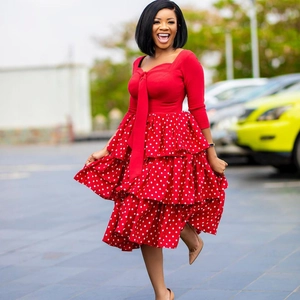 Red long sleeve polka dot dress with layered ruffles and elegant bow tie neckline