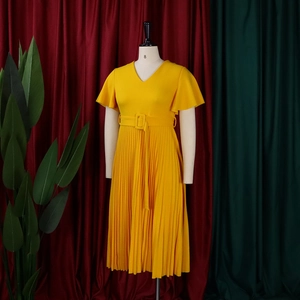 Close-up of bright yellow V-neck pleated dress featuring ruffle sleeves and matching belt