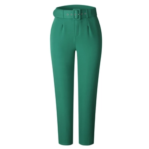 Detailed view of high-waisted dark green dress pants with matching belt and pleats