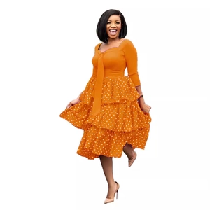 Vibrant orange polka dot long sleeve maxi dress with square neck and tiered cake skirt