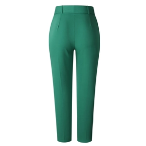 Detail of high-waisted dark green dress pants showing back tailoring and waist darts