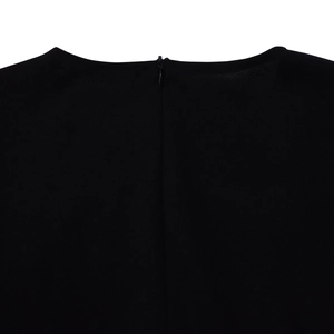 Detail view of the elegant black dress featuring a hidden zipper and premium fabric texture