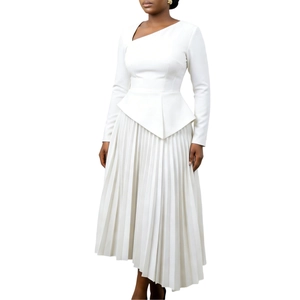 Detail of white long sleeve dress showing asymmetric neck and peplum waist pleats