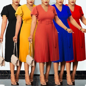 Detail view of colorful pleated midi dresses with V-neckline and waist belts in five colors
