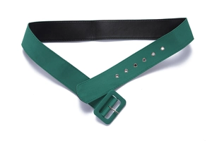 Detail of high-waist dark green fabric belt with metal eyelets and matching square buckle