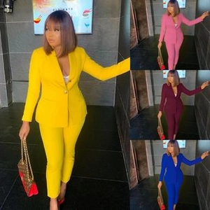 Detail view of stylish two-piece women's professional suit with puff sleeves in multiple colors