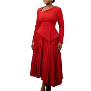 Detail of elegant red asymmetric dress showing pleated hem and waist peplum ruffles