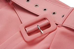 Detailed view of pink trousers showing waist belt fabric buckle and metal eyelet details