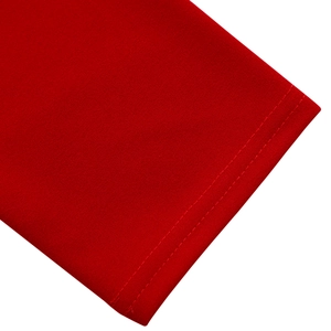 Detailed close-up of high-quality red fabric with precise double-needle stitching hem