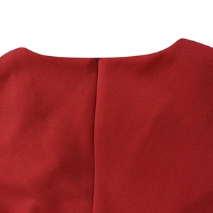 Detail of dark red dress showing the high-quality textured fabric and invisible zipper