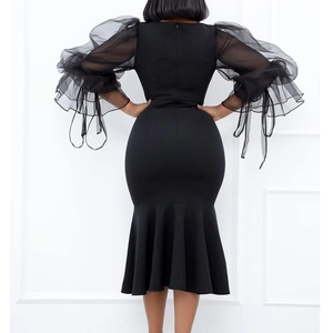 Elegant black mermaid dress with sheer mesh puff sleeves and ruffled cuffs back view