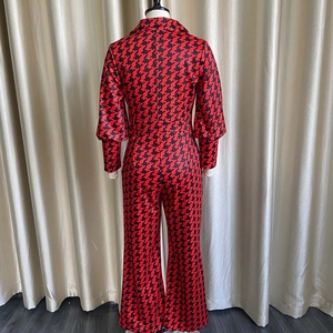 Back view of high-waist jumpsuit with red and black geometric pattern and lantern sleeves