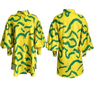 Front and back view of a yellow printed shirt dress with green abstract brushstrokes