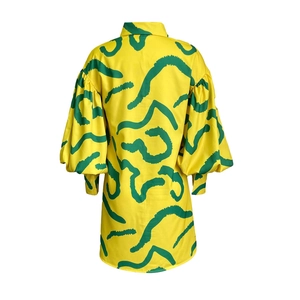 Back view detail of yellow lantern sleeve dress with green abstract brushstroke prints