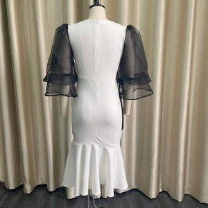 Detail view of back zipper on mermaid dress with black mesh sleeves and white body