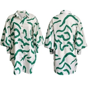 Front and back view of long-sleeve oversized white shirt dress with green abstract print