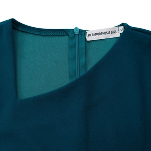 Detail of elegant asymmetric neckline with invisible zipper and high-quality knit texture