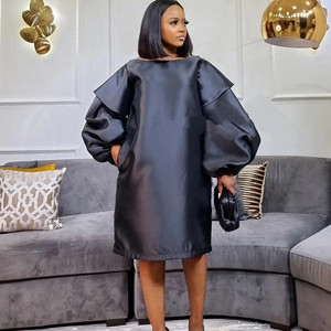 Elegant black puff sleeve dress in satin fabric with a modern minimalist loose silhouette
