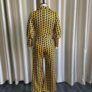 Rear view detail of V-neck long sleeve jumpsuit with yellow and black geometric patterns
