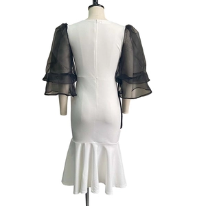 Detailed back view of two-tone mermaid dress with sheer mesh sleeves and zipper