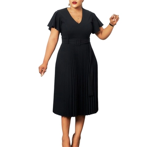 Detail of black V-neck dress featuring pleated skirt and ruffle sleeves with belt