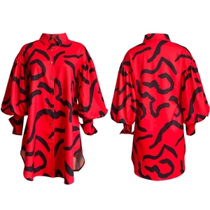 Front and back view of red shirt dress with black abstract print and asymmetric hem