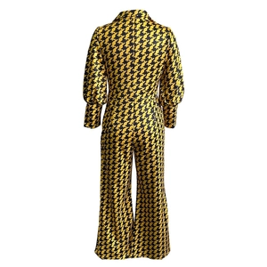 Rear view of long sleeve jumpsuit featuring yellow geometric patterns and wide-leg cut