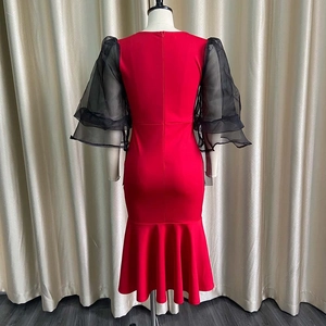 Detail of the back zipper and mesh lantern sleeves on the red fishtail evening dress