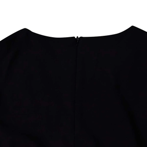 Detail view of the seamless invisible zipper on the back neckline of the black dress