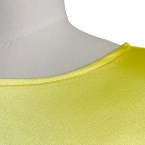 Detail of round neckline with high-gloss satin yellow fabric and neat stitching craftsmanship