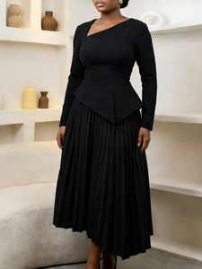 Elegant black long-sleeve dress with asymmetrical neck, peplum waist, and pleated skirt