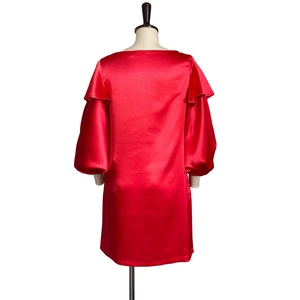 Back view of red satin dress featuring elegant puff sleeves and a loose-fitting silhouette