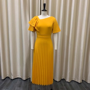 Detail of elegant ruffle shoulder and pleated skirt on a bright yellow midi dress